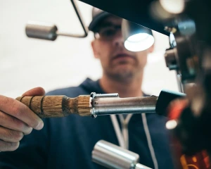 A professional locksmith technician working on a lock.